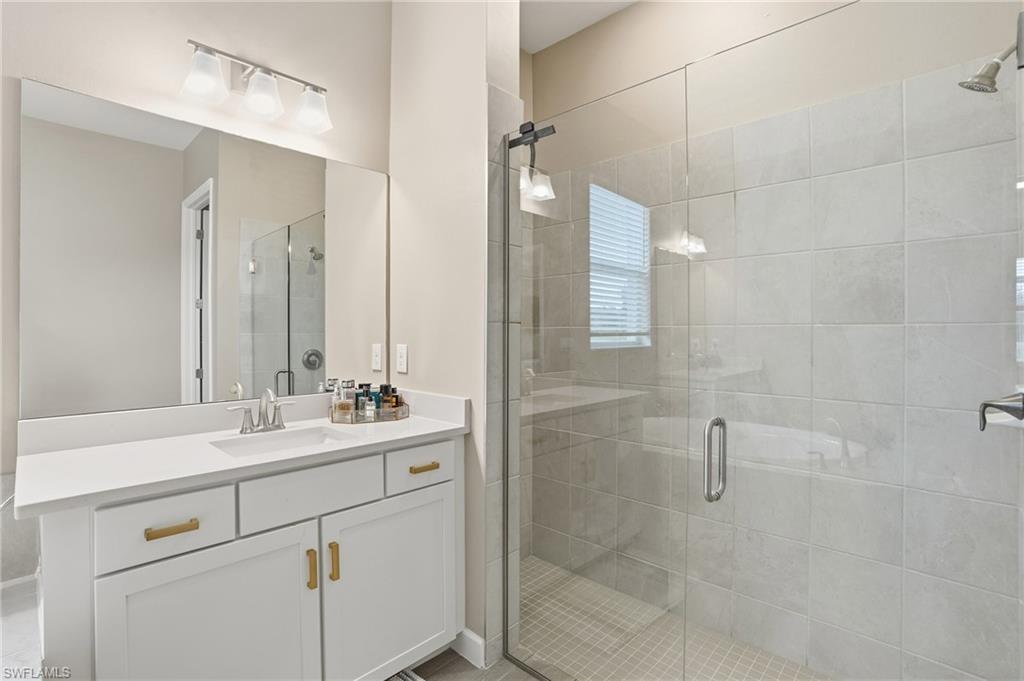 17120 Serengeti Circle Alva, FL 33920 - Photo 28 of 50 a bathroom with a sink and mirror