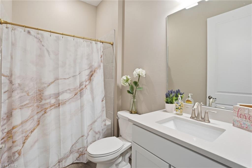17120 Serengeti Circle Alva, FL 33920 - Photo 34 of 50 a bathroom with a granite countertop sink and a mirror