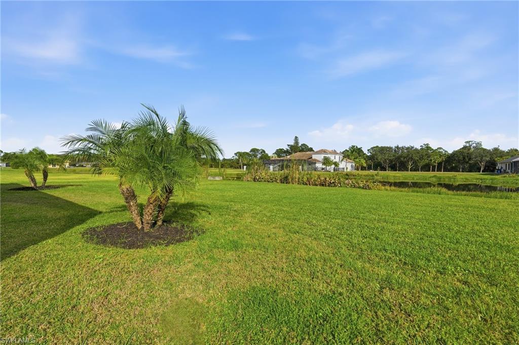 17120 Serengeti Circle Alva, FL 33920 - Photo 43 of 50 a view of a garden with a building in the background
