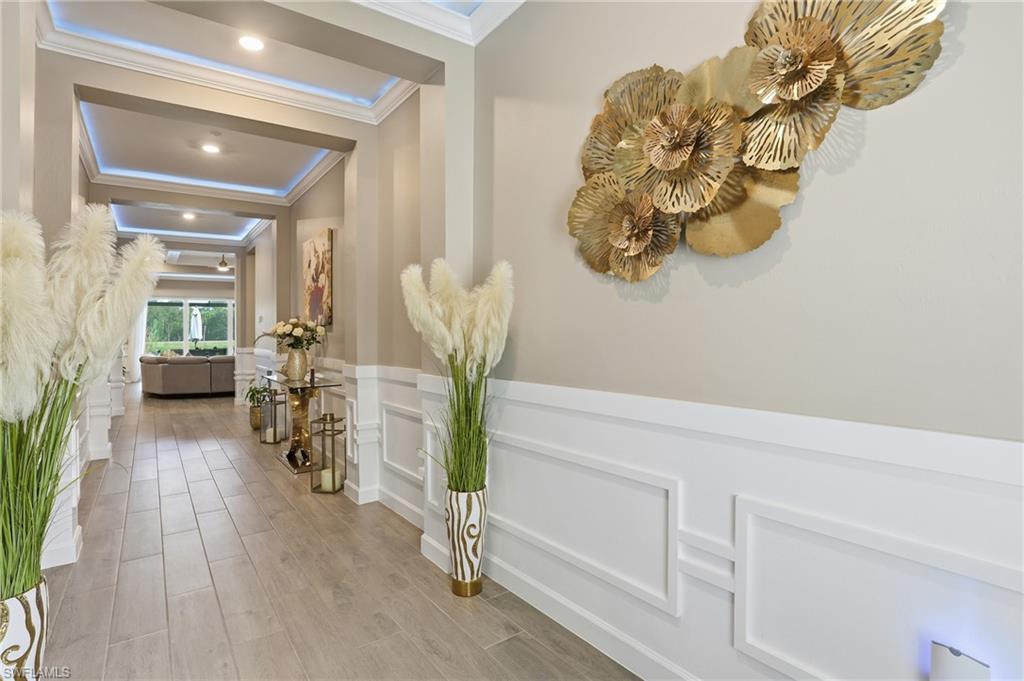 17120 Serengeti Circle Alva, FL 33920 - Photo 10 of 50 a hallway with a white flower pot and wooden floor