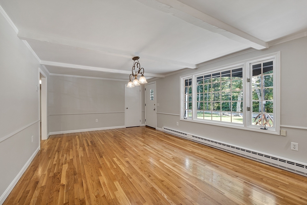 707 Sterling Road Lancaster, MA 01523 - Photo 15 of 40 a view of an empty room with a window and wooden floor