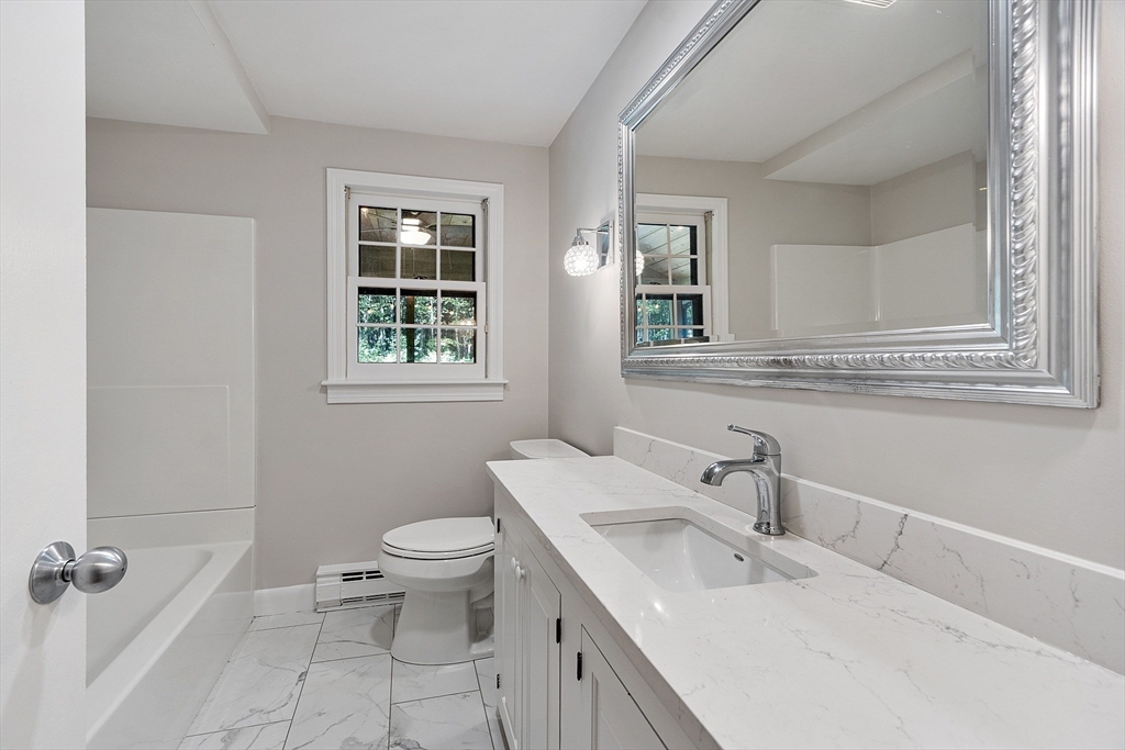 707 Sterling Road Lancaster, MA 01523 - Photo 16 of 40 a bathroom with a toilet sink and mirror