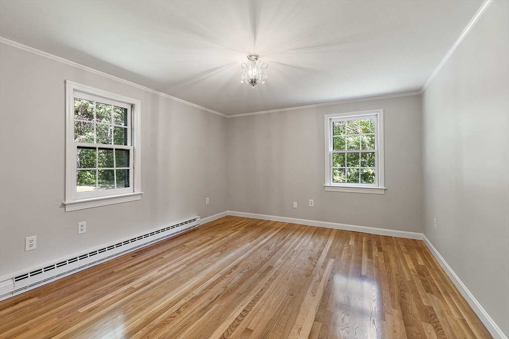 707 Sterling Road Lancaster, MA 01523 - Photo 17 of 40 a view of an empty room with wooden floor and a window