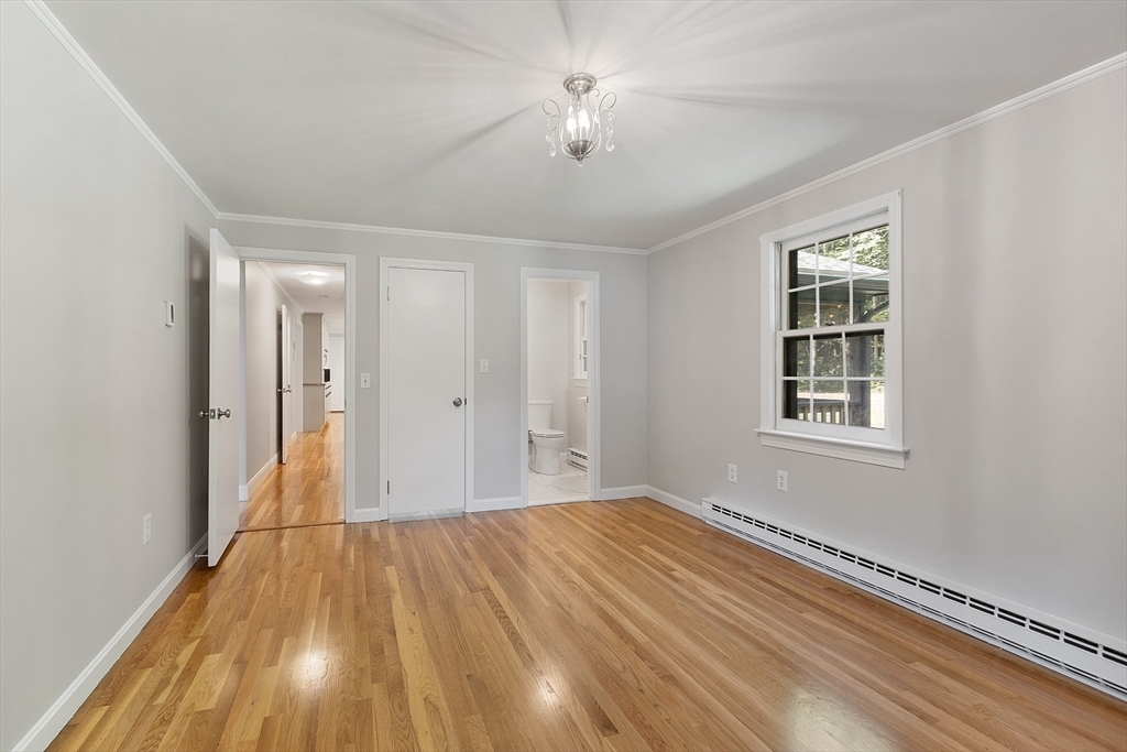 707 Sterling Road Lancaster, MA 01523 - Photo 18 of 40 a view of empty room with wooden floor and fan