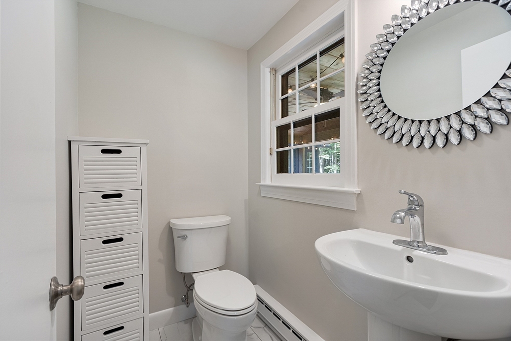707 Sterling Road Lancaster, MA 01523 - Photo 19 of 40 a bathroom with a toilet a sink and mirror