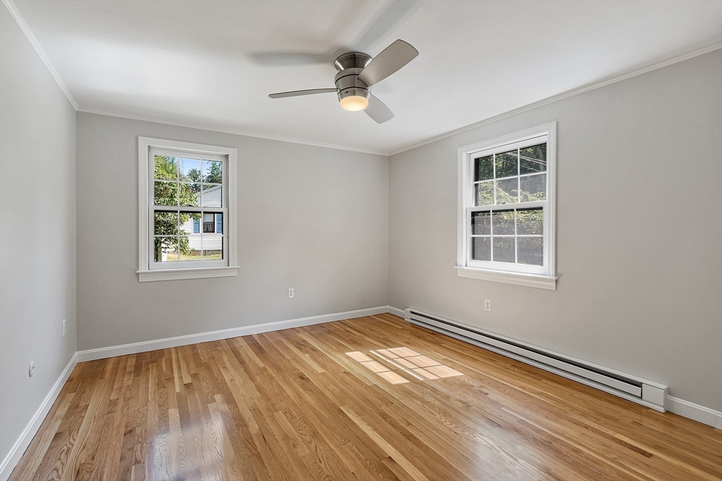 707 Sterling Road Lancaster, MA 01523 - Photo 20 of 40 a view of empty room with wooden floor and fan