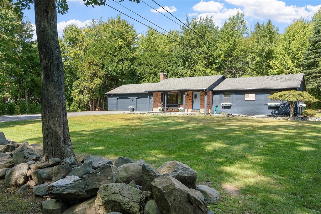 707 Sterling Road Lancaster, MA 01523 - Photo 2 of 40 a front view of a house with a garden and swimming pool