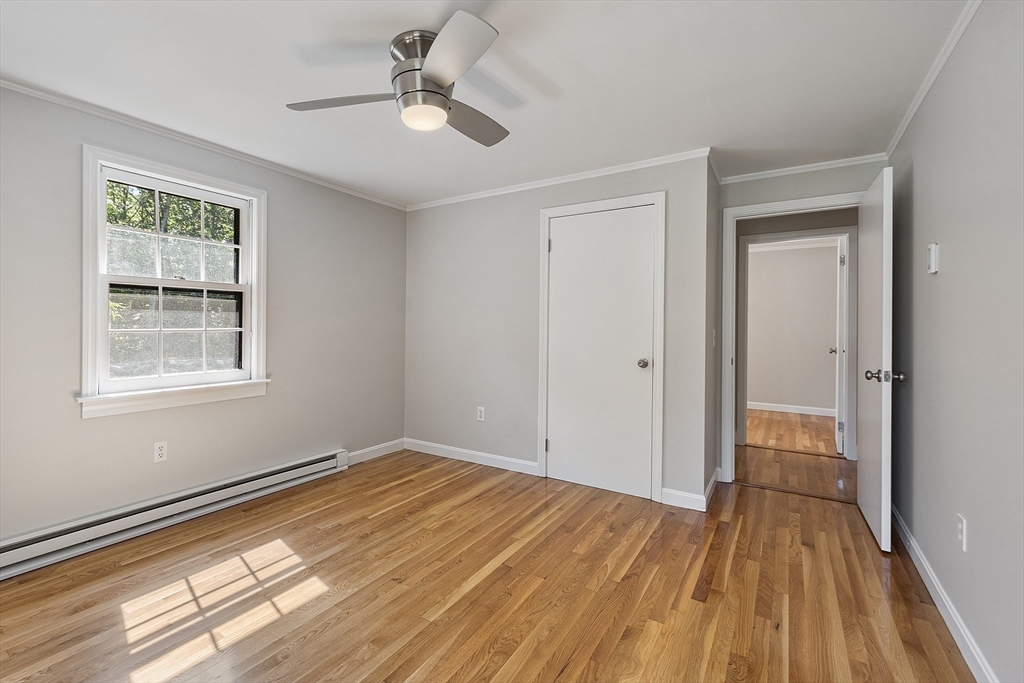 707 Sterling Road Lancaster, MA 01523 - Photo 21 of 40 a view of empty room with wooden floor and fan