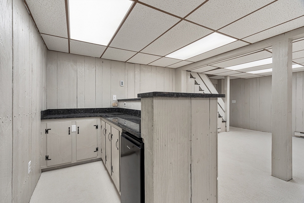 707 Sterling Road Lancaster, MA 01523 - Photo 25 of 40 a utility room with cabinets washer and dryer