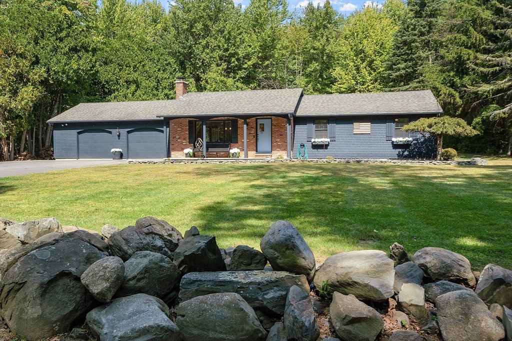 707 Sterling Road Lancaster, MA 01523 - Photo 37 of 40 a view of a house with a big yard and a large tree