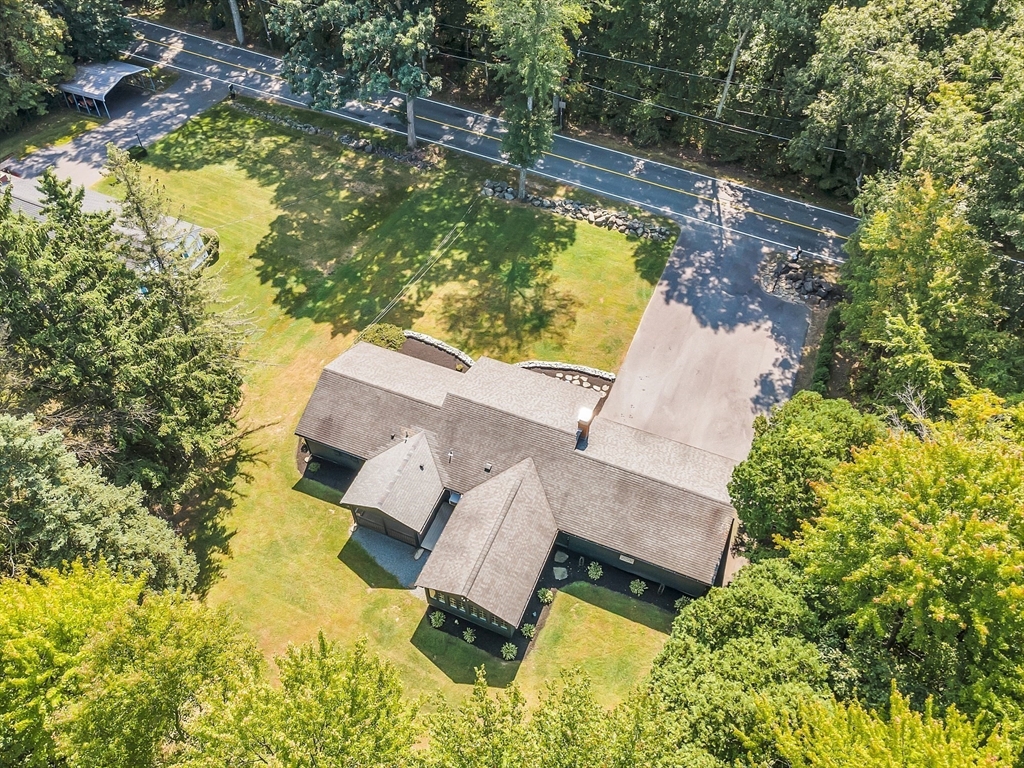 707 Sterling Road Lancaster, MA 01523 - Photo 4 of 40 an aerial view of a house with swimming pool and large trees