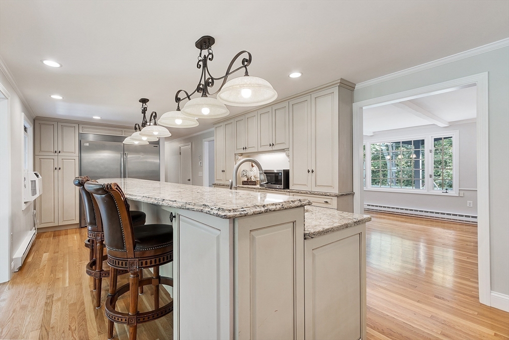 707 Sterling Road Lancaster, MA 01523 - Photo 7 of 40 a kitchen with stainless steel appliances granite countertop a stove and a wooden floors