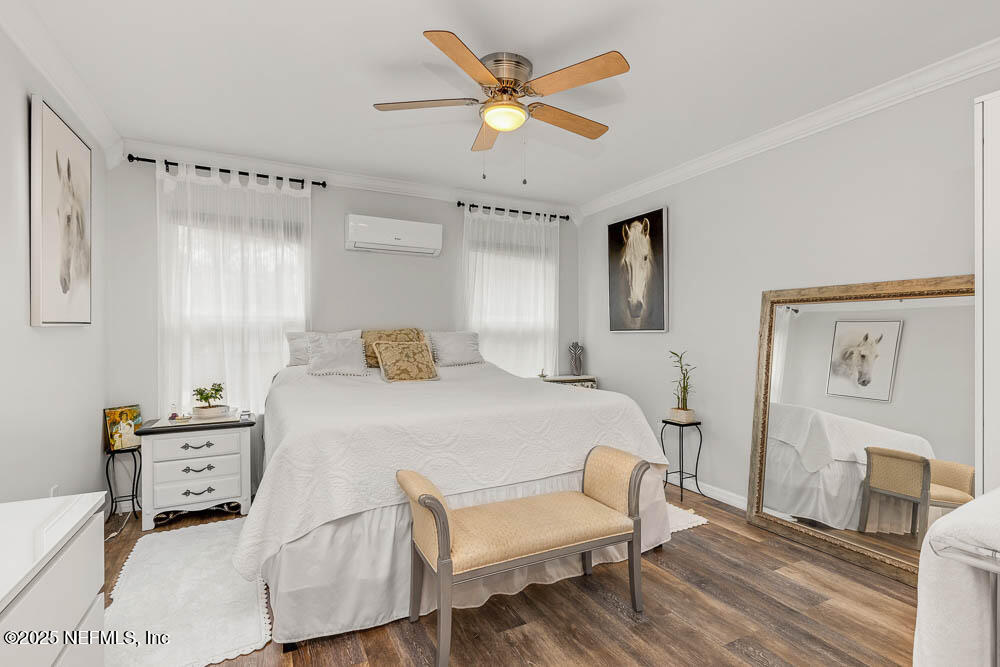 1228 Glen Laura Road Jacksonville, FL 32205 - Photo 11 of 40 a bedroom with a bed chandelier and a window