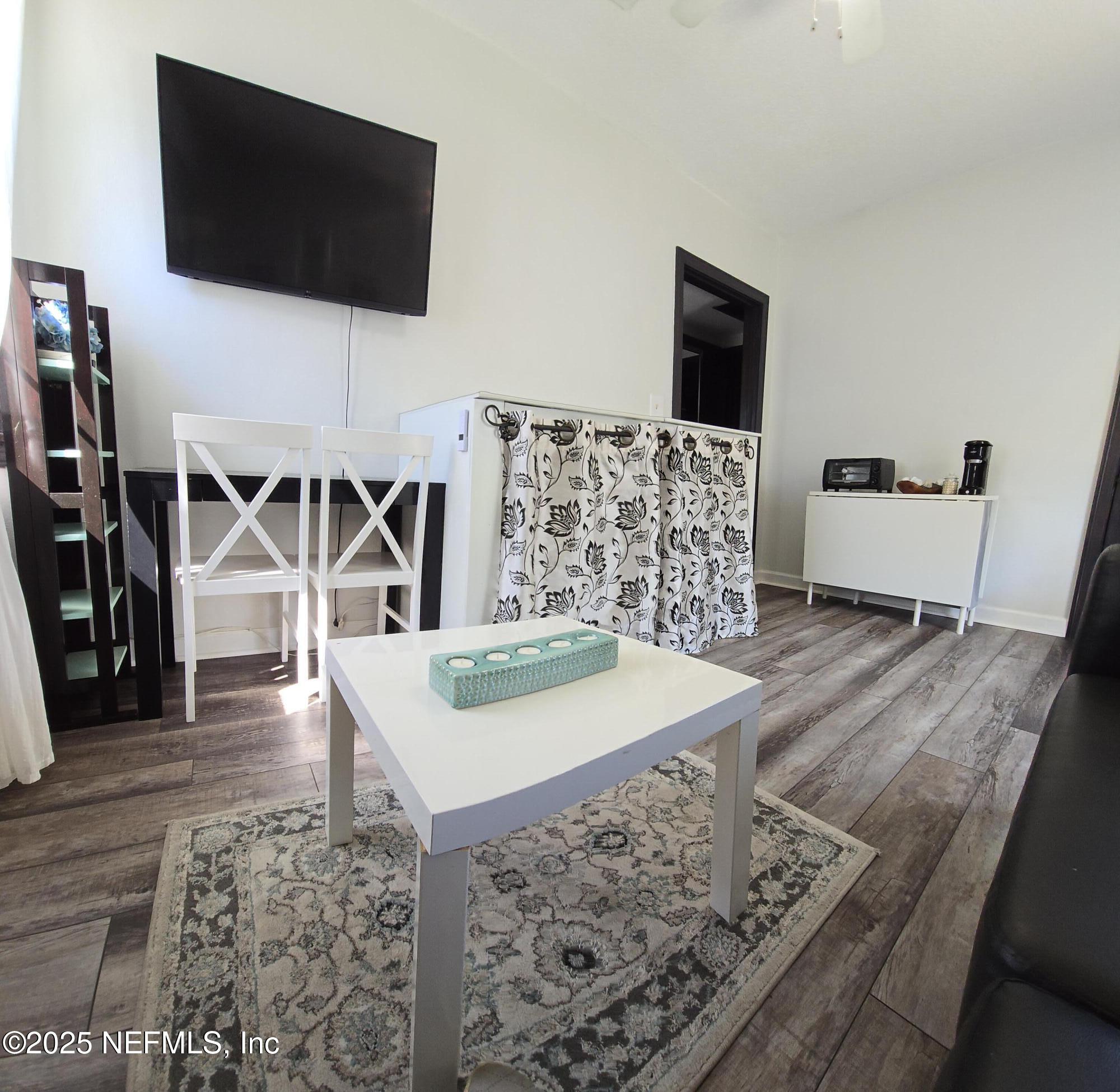 1228 Glen Laura Road Jacksonville, FL 32205 - Photo 14 of 40 a living room with furniture and a flat screen tv