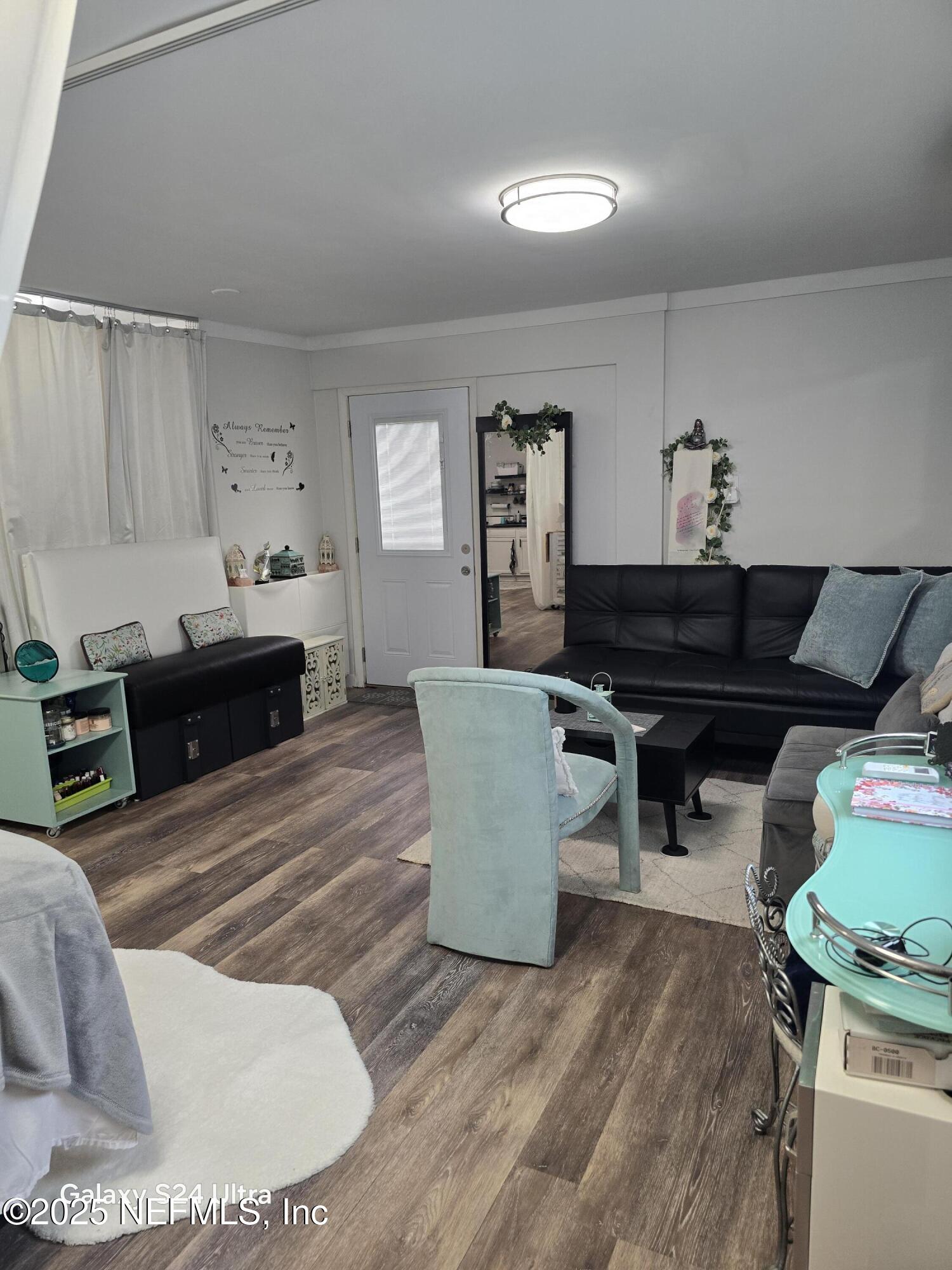1228 Glen Laura Road Jacksonville, FL 32205 - Photo 15 of 40 a living room with furniture and a wooden floor