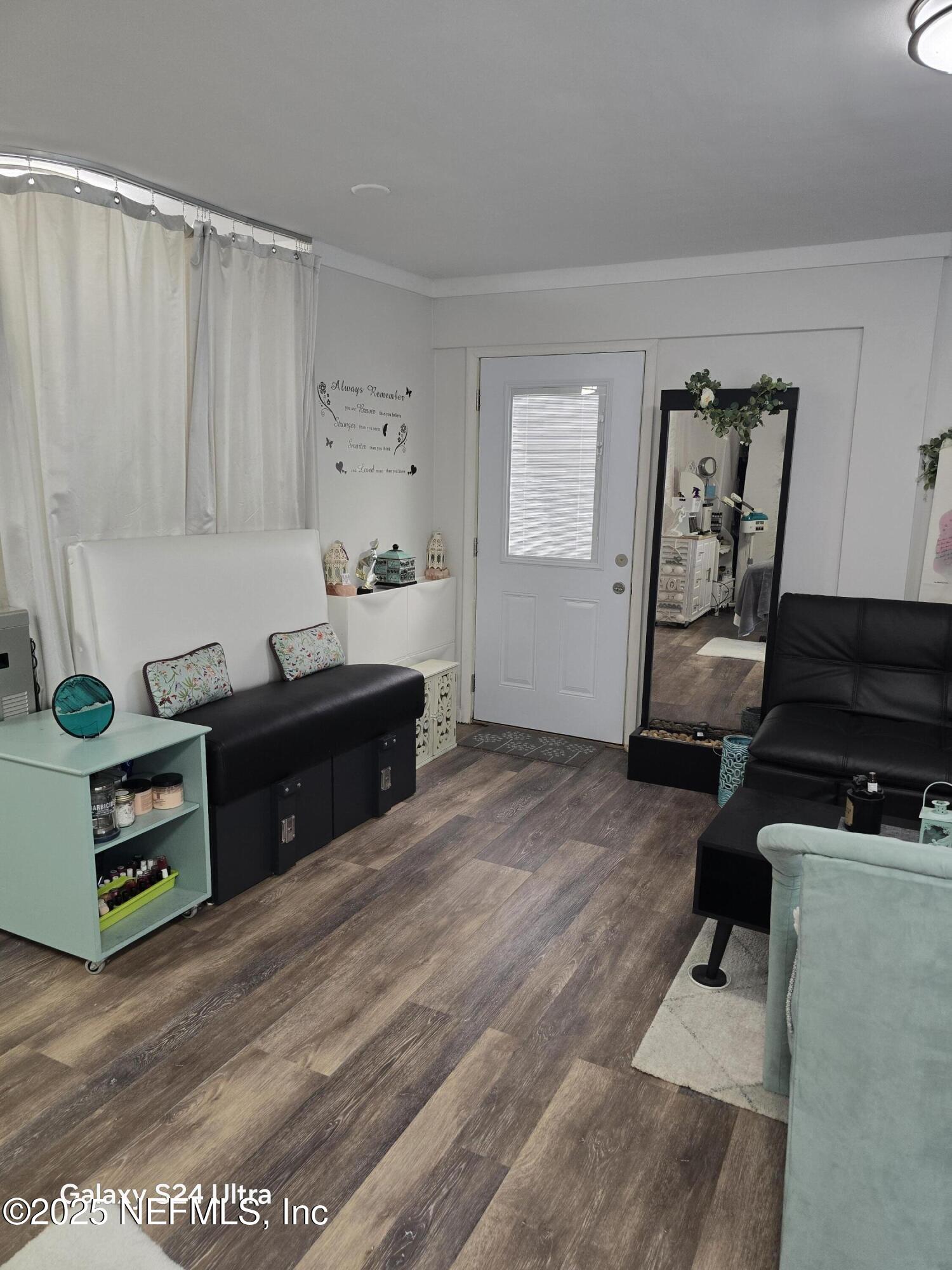 1228 Glen Laura Road Jacksonville, FL 32205 - Photo 16 of 40 a living room with a dresser and a window