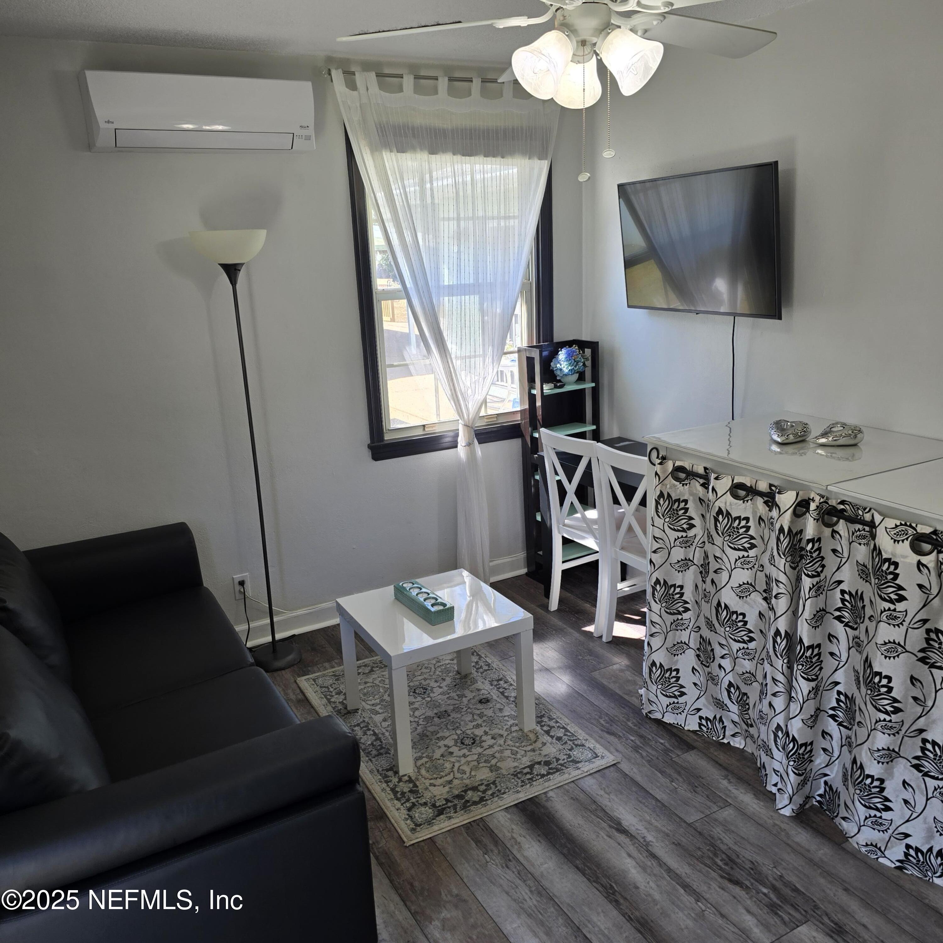 1228 Glen Laura Road Jacksonville, FL 32205 - Photo 17 of 40 a living room with furniture and a flat screen tv
