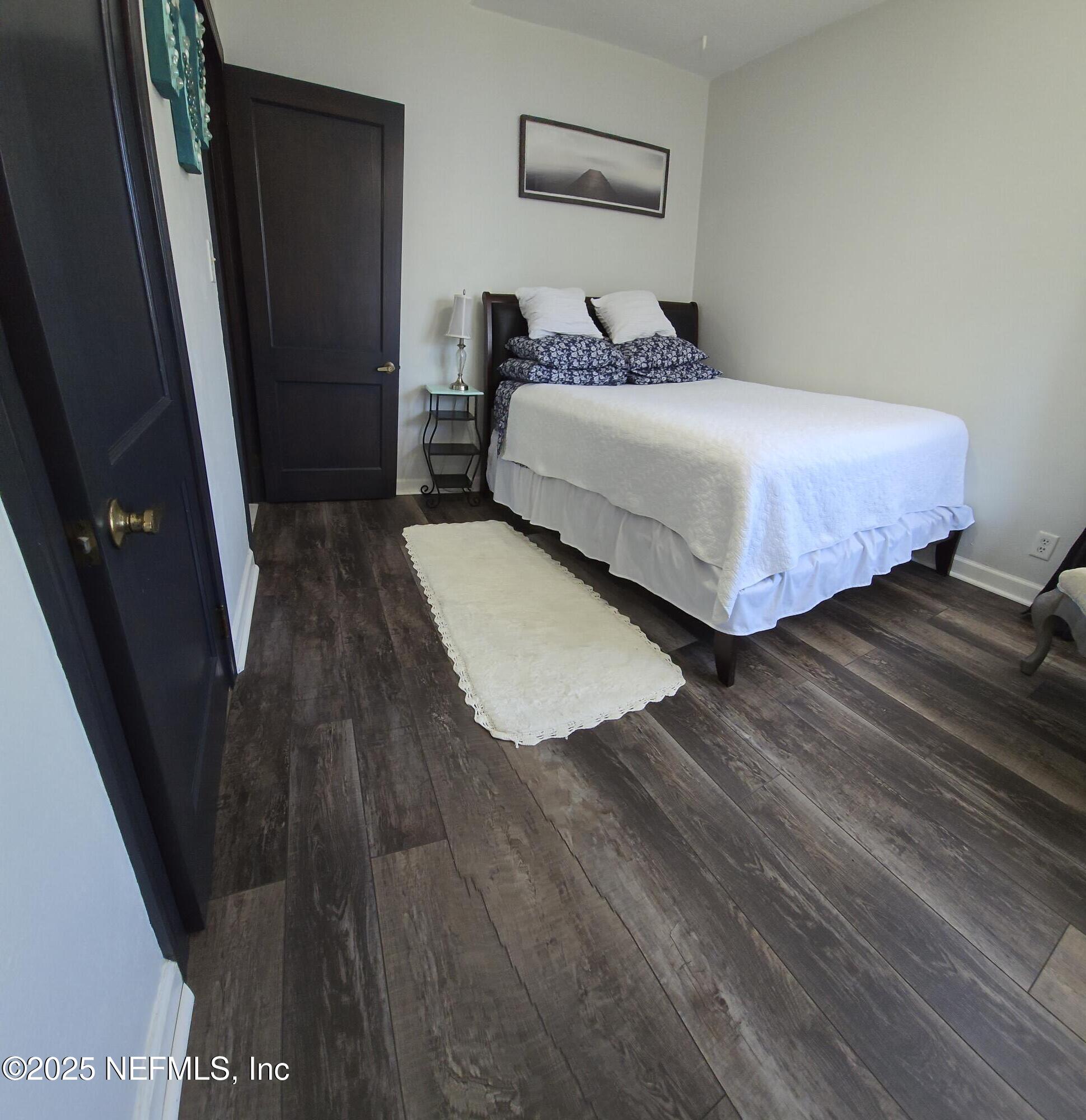1228 Glen Laura Road Jacksonville, FL 32205 - Photo 18 of 40 a bedroom with a bed and a mirror