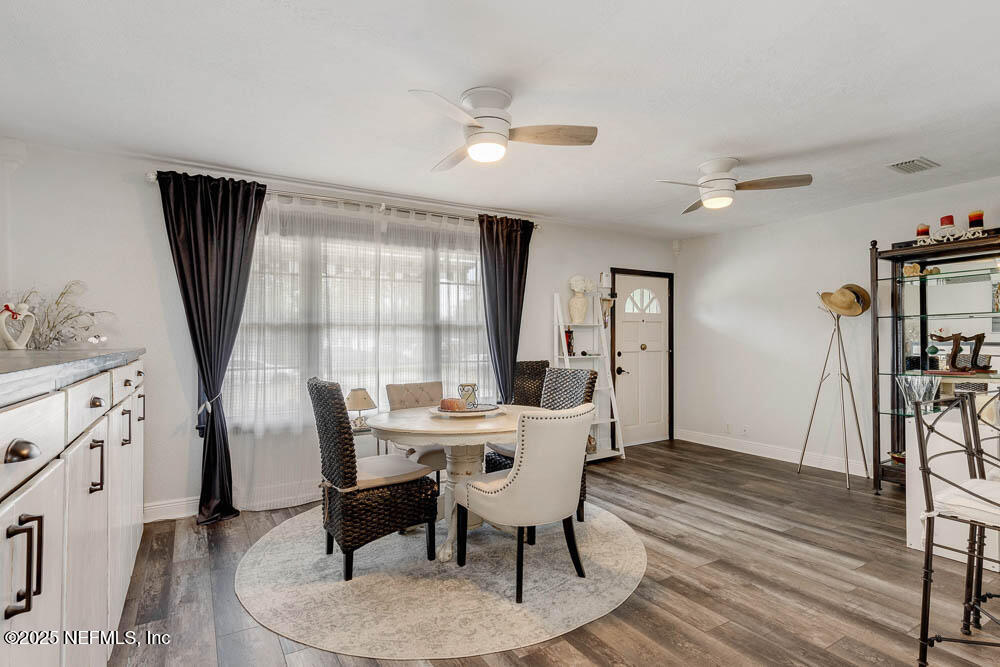 1228 Glen Laura Road Jacksonville, FL 32205 - Photo 2 of 40 a view of a dining room with furniture window and wooden floor