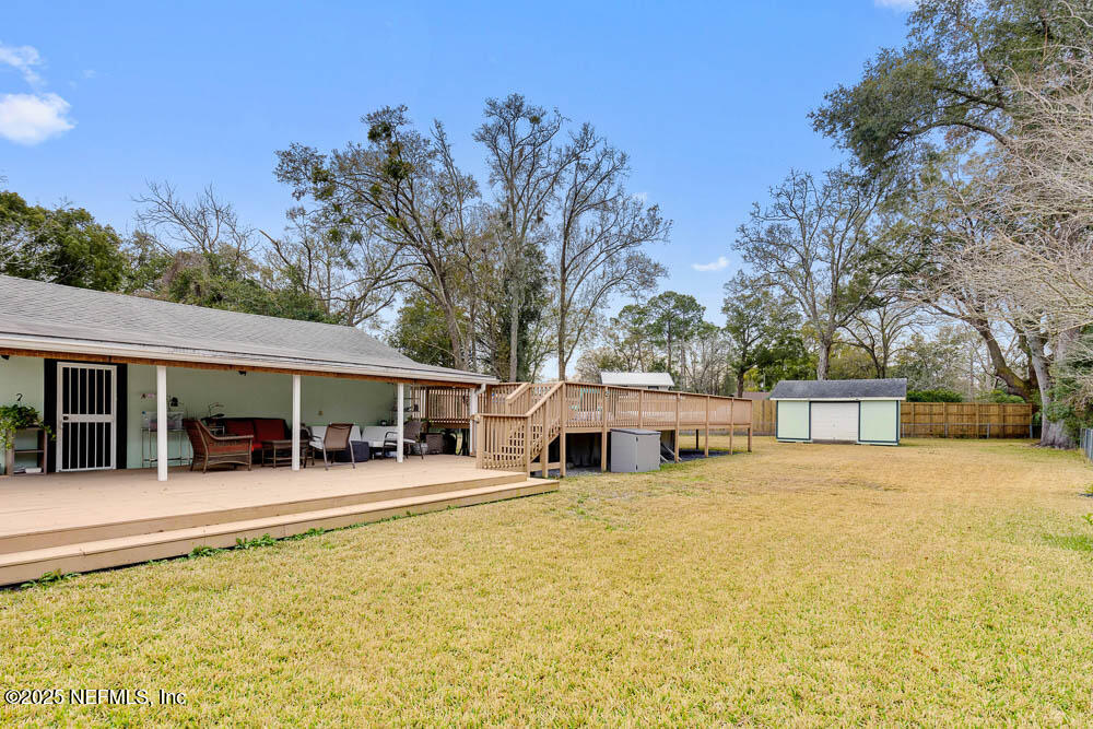1228 Glen Laura Road Jacksonville, FL 32205 - Photo 26 of 40 a view of a house with a yard patio and fire pit