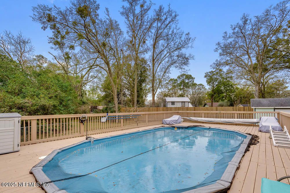 1228 Glen Laura Road Jacksonville, FL 32205 - Photo 28 of 40 a view of a swimming pool with a patio and a yard