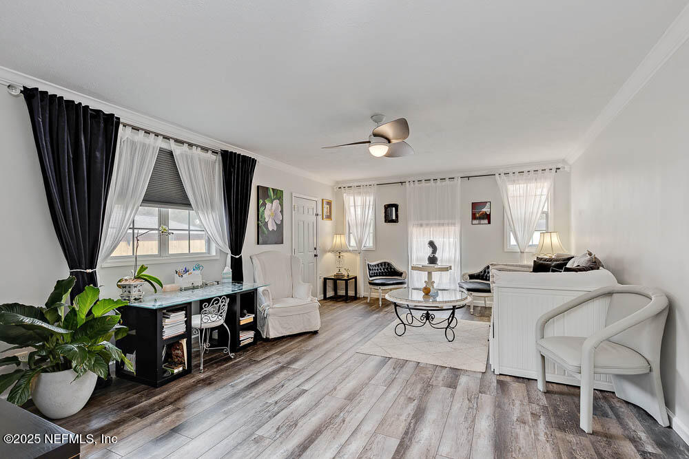 1228 Glen Laura Road Jacksonville, FL 32205 - Photo 6 of 40 a living room with furniture a window and wooden floor