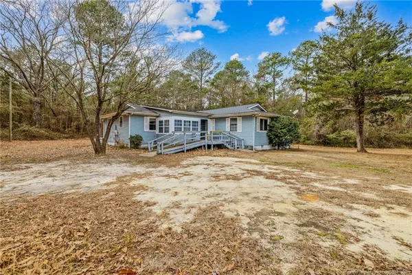 a house with trees in the background