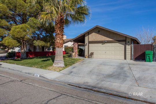 204 North Broadway Street Ridgecrest, CA 93555 - Photo 2 of 29 a front view of a house with a yard and garage