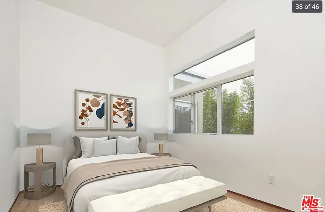 a bedroom with a bed and a large window