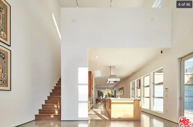 a view of a hallway with wooden floor and staircase
