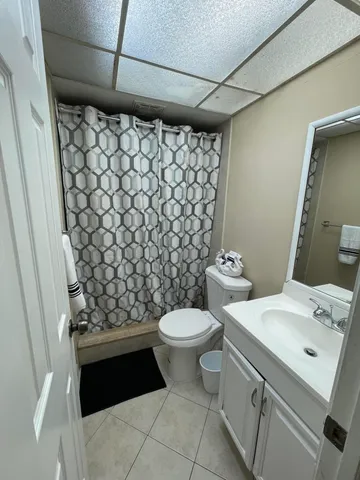 a bathroom with a double vanity sink toilet and shower