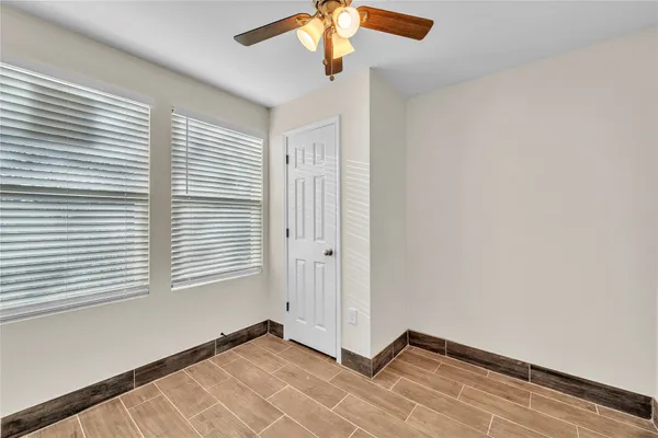 an empty room with a chandelier fan