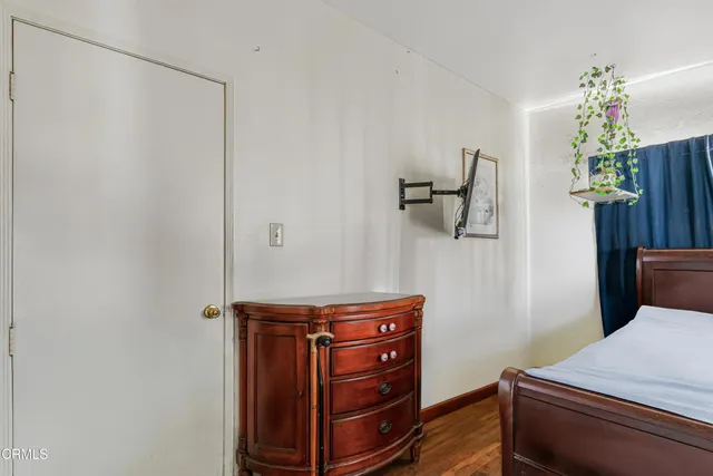 a room with a dresser and a chandelier