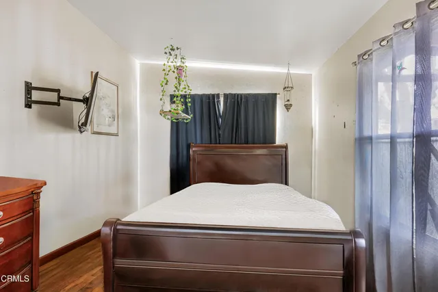 a bedroom with a bed and a dresser