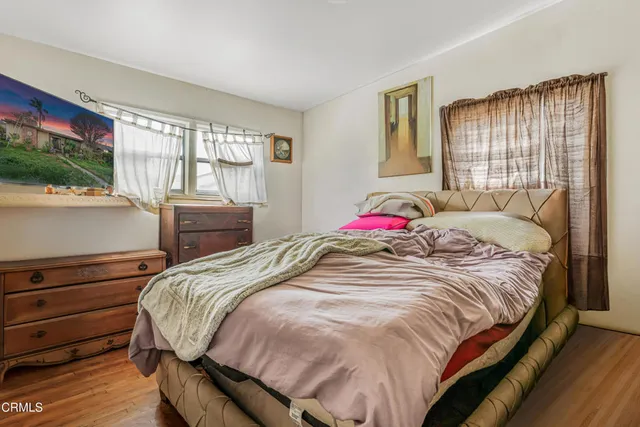 a bed sitting in a bedroom next to a window