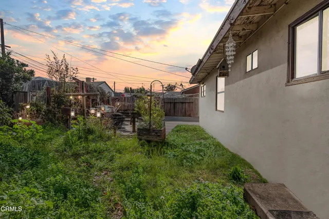 a backyard of a house with table and chairs