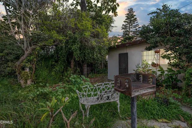 a view of a chair and table in the garden