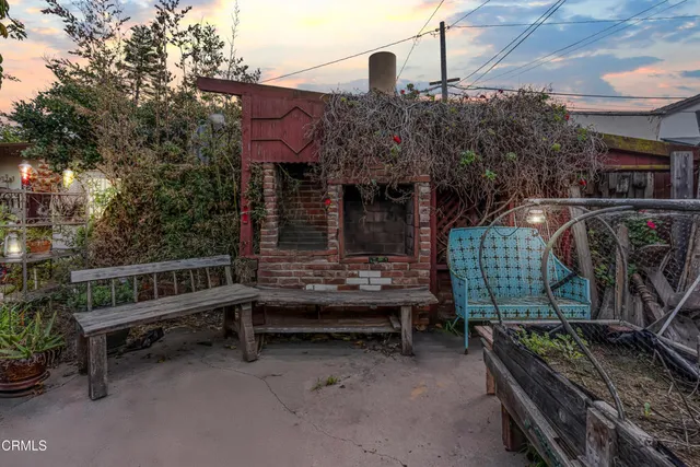 a front view of a house with balcony and wooden fence