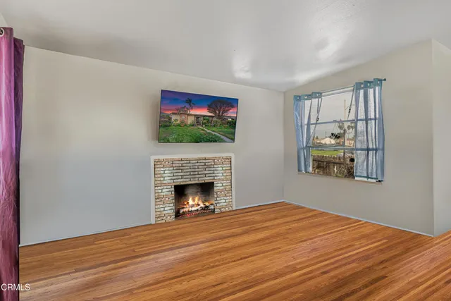 a workspace with fireplace wooden floor and window