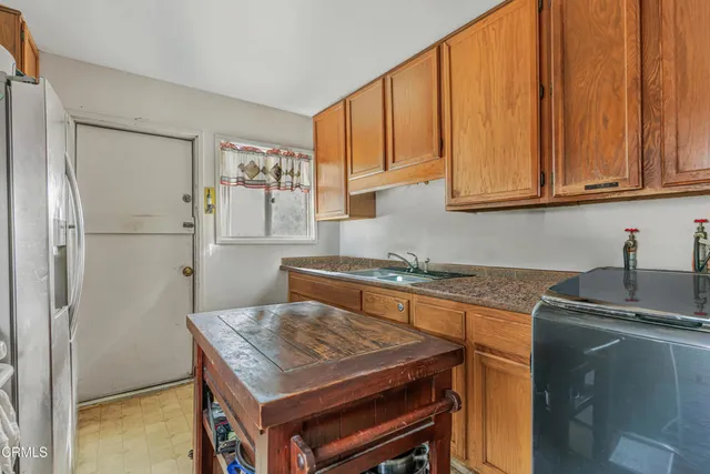 a kitchen with stainless steel appliances granite countertop a refrigerator sink and cabinets