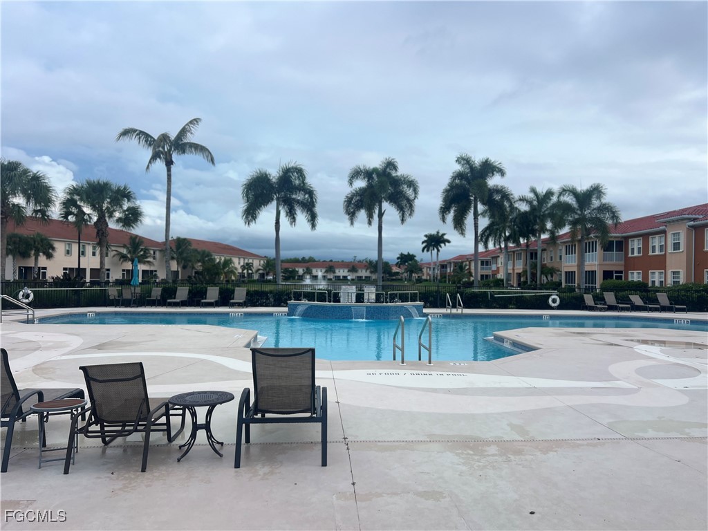 10132 Via Colomba Circle Fort Myers, FL 33966 - Photo 14 of 15 a view of a swimming pool with outdoor seating and plants
