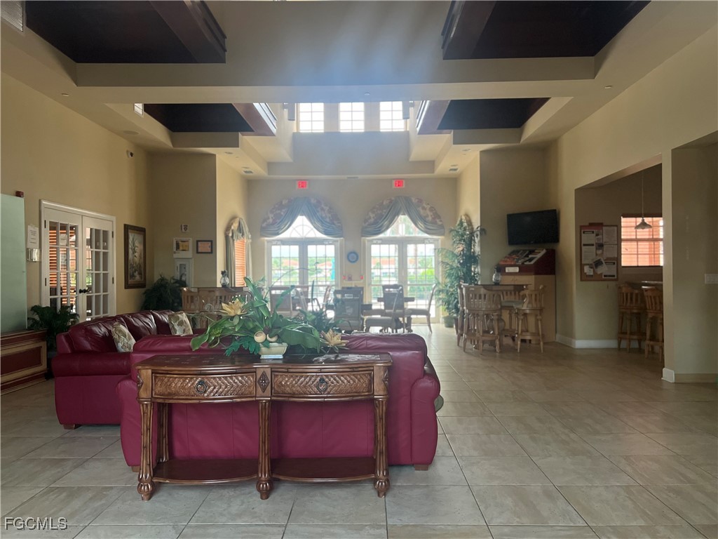 10132 Via Colomba Circle Fort Myers, FL 33966 - Photo 15 of 15 a living room with furniture a chandelier and a flat screen tv
