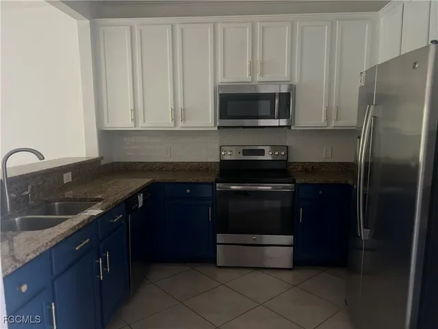 a kitchen with a refrigerator and a sink