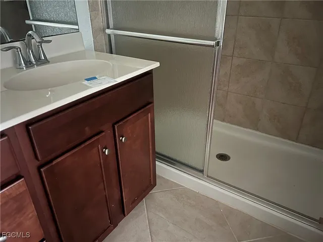 a bathroom with a shower and a sink
