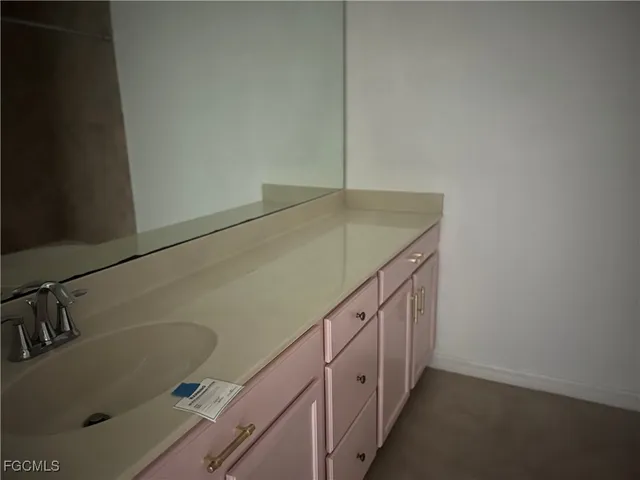 a bathroom with a sink and vanity