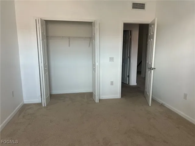 an empty room that has a grey walls
