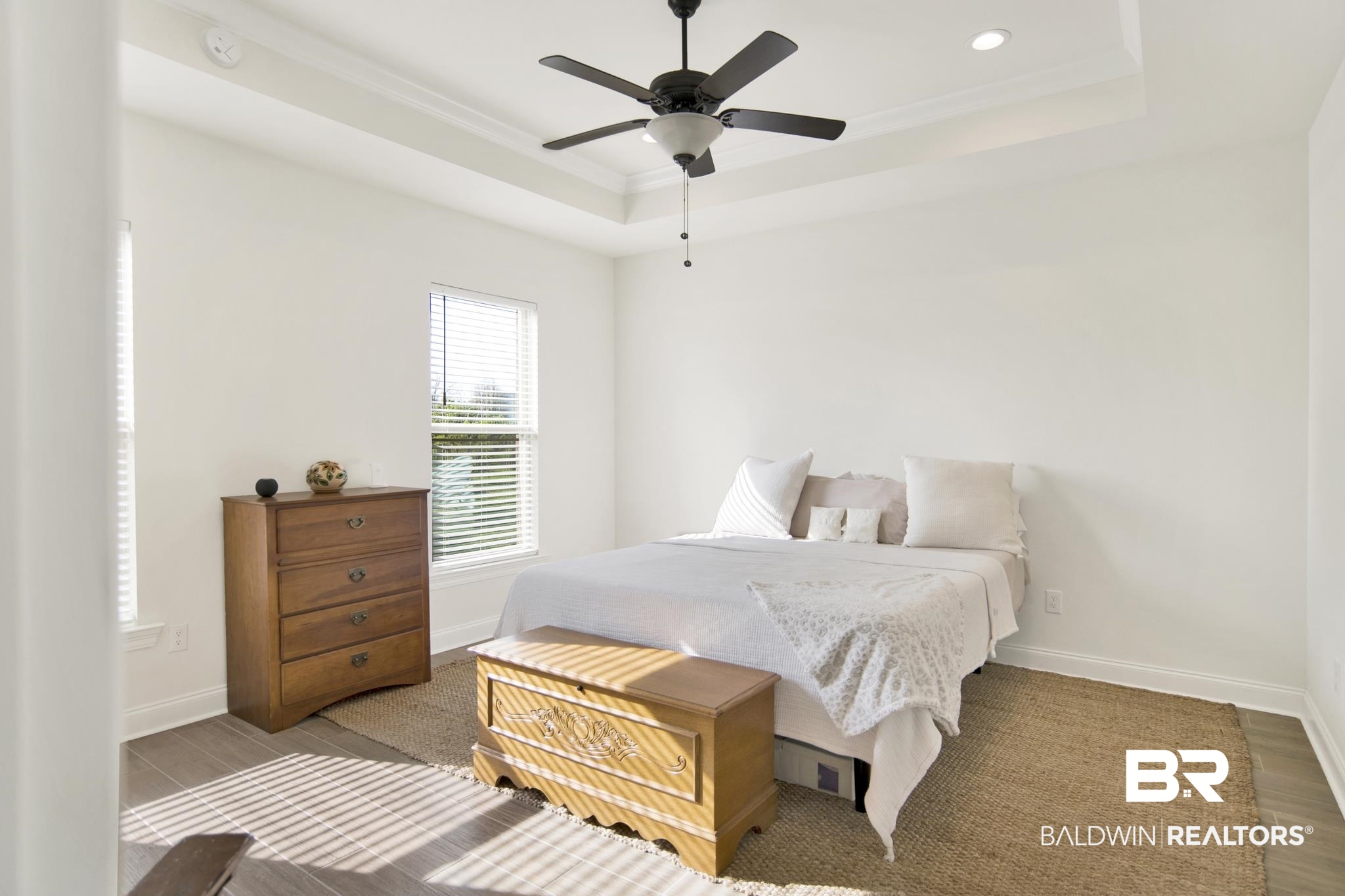 22258 Hibiscus Circle Foley, AL 36535 - Photo 15 of 26 Bedroom with baseboards, a tray ceiling, and ornamental molding