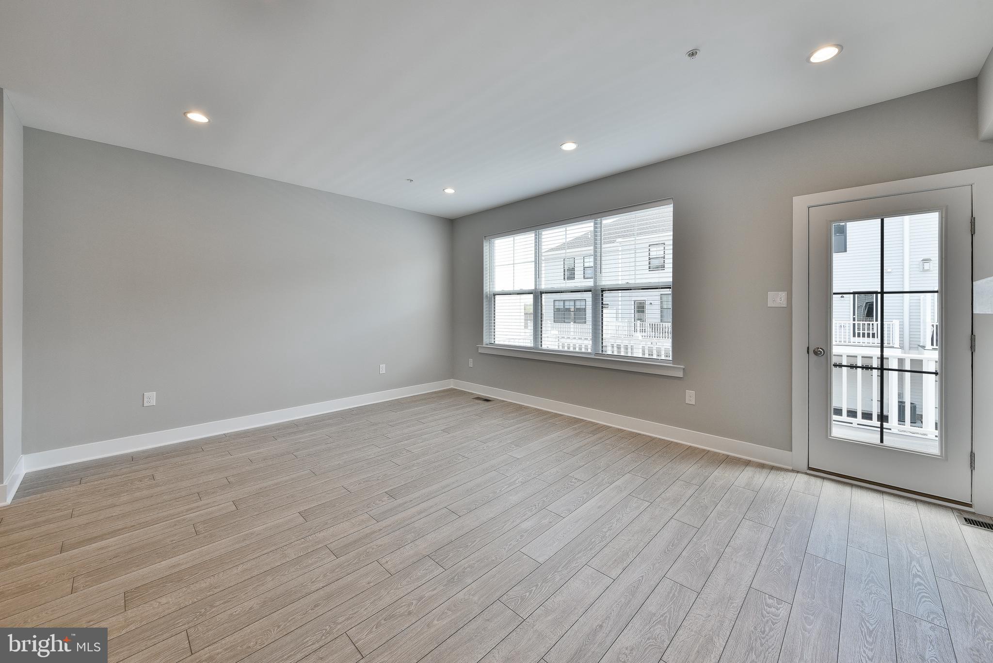 328 Walnut Street Collegeville, PA 19426 - Photo 14 of 35 an empty room with wooden floor and windows