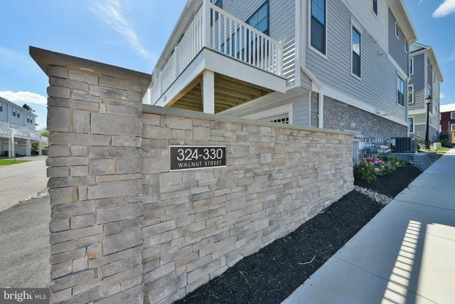 a view of a house with wooden deck