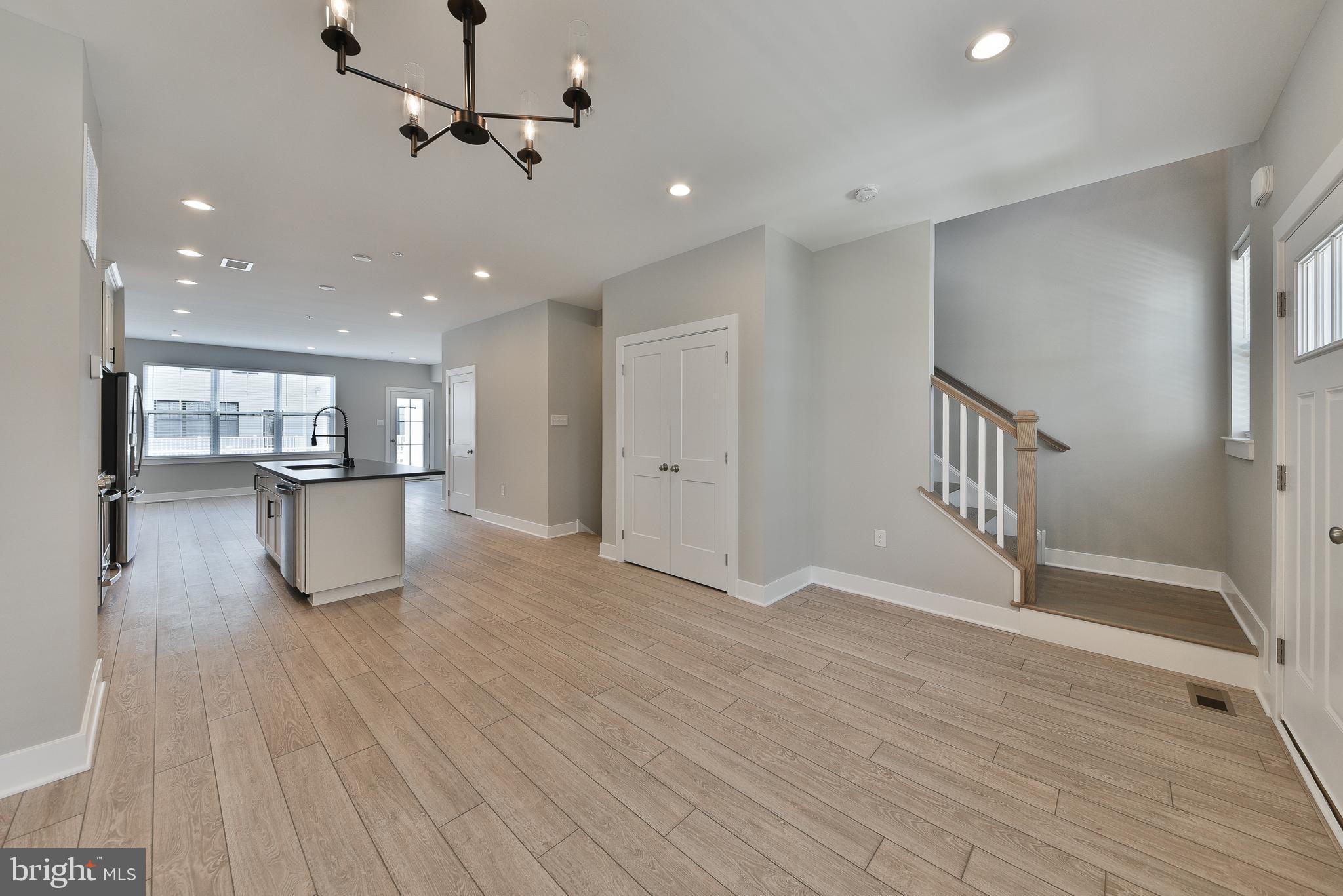 328 Walnut Street Collegeville, PA 19426 - Photo 6 of 35 a view of an empty room with wooden floor and a ceiling fan